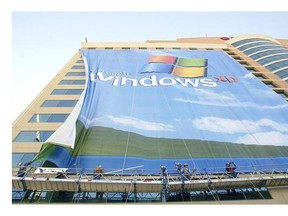 In this Nov. 8 2001 file photo, workers install a 10-story Windows XP banner on a hotel near the Las Vegas Convention Center in Las Vegas.