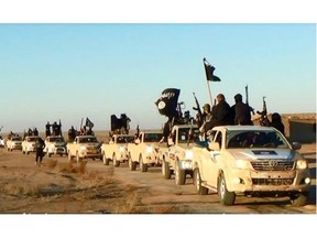 This file image posted on a militant website on Tuesday, Jan. 7, 2014, which is consistent with AP reporting, shows a convoy of vehicles and fighters from the al-Qaida linked Islamic State of Iraq and the Levant (ISIL) fighters in Iraq’s Anbar Province. The Islamic State group holds roughly a third of Iraq and Syria, including several strategically important cities like Fallujah and Mosul in Iraq and Raqqa in Syria. It rules over a population of several million people with its strict interpretation of Islamic law.