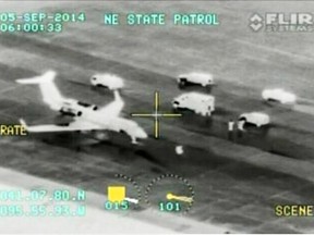 In this frame grab made from video which was released by the Nebraska State Patrol, the plane transporting Dr. Rick Sacra, 51, who was infected with Ebola while serving as a family doctor in Liberia, sits on the tarmac at Offutt airforce base in Bellevue, Neb., Friday Sept. 5, 2014, before being transported to the Nebraska Medical Center in Omaha. Sacra, who served with North Carolina-based charity SIM, is the third American aid worker infected by the Ebola virus.