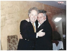 On Thursday, September 4, 2014  this picture was entered into evidence at the Charbonneau Commission, showing former premier Jean Charest grinning broadly as he embraces construction magnate Tony Accurso. Along one side of the image, a handwritten message from Charest reads: Dear Tony, thanks for your support. In friendship, Charest 2001.
