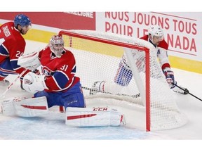 Tomas Plekanec goes behind Carey Price’s net while Jarred Tinordi chases during the Montreal Canadiens Red-White intra-squad game at the Bell Centre in Montreal Monday, Sept. 22, 2014.