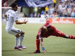 Vancouver Whitecaps FC Mehdi Ballouchy, tries to get the ball past San Joes Earthquakes’ Jordan Stewart during second half of MLS soccer action in Vancouver, on Wednesday, Sept., 10, 2014.