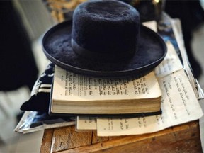 View of a hat and the Torah of a members of an ultra-Orthodox Lev Tahor Jewish group at the building where the group will remain in Guatemala City on September 2, 2014. Some 230 ultra-Orthodox Lev Tahor Jews were expelled from the town of San Juan La Laguna by Mayan indigenous leaders.