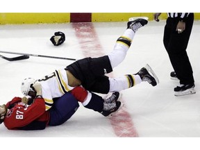 Washington Capitals' Liam O'Brien (87) and Boston Bruins' Bobby Robins, top, fight during the first period of a preseason hockey game, Friday, Sept. 26, 2014, in Washington. The Capitals won 5-4 in overtime.