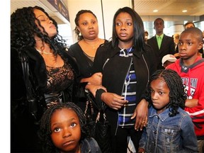 Winifred Agimelen, middle, and her three children: Friends and supporters gathered to support them at the Dorval airport on Sunday September 14, 2014 few hours before their flight back to Nigeria.