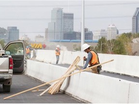 Workers in the final phase of construction on a new temporary bridge between Nuns’ Island and Downtown Montreal, Monday, September 29, 2014. Transport Canada announced that the bridge is to be completed ahead of time and under budget.