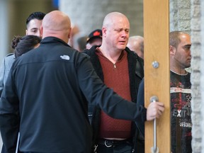 The stepfather of homicide victim Jenique Dalcourt, centre, and other family members arrive at a hearing for a suspect in the case at the Longueuil courthouse on Monday, Oct. 27, 2014.