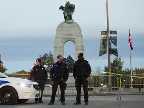 Police remain on the scene Oct. 23 at the Cenotaph where a soldier was shot dead Oct. 22. The gunman was later killed when he stalked the halls of Parliament Hill.