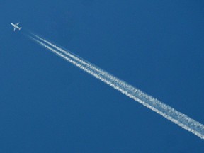 An airplane against a blue sky.