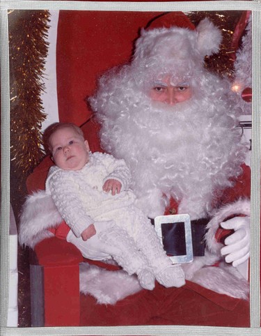 Simon, 4 mths old, decides it's never too young to start a good relationship with Santa.