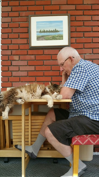 Grandpa reading at the table, for Missy, means time to snuggle.