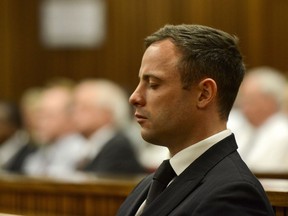 Oscar Pistorius stands as he listens to his judgement in the Pretoria High Court on October 21, 2014, in Pretoria, South Africa. Judge Thokozile Masipa handed down her sentence today. Pistorius was sentenced to five years in prison.