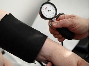 A doctor measures the blood pressure of a man in Stuttgart, Germany, Feb.6, 2009. It may be good for your peace of mind and flexibility. But yoga and mindfulness meditation doesn't lower blood pressure, a new study reports.