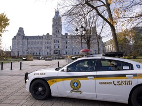 A Surete du Quebec cruiser guards the front of the National Assembly after a gunman opened fire in Ottawa on parliament Hill, Oct. 22, 2014.