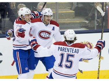 Montreal Canadiens, left to right, Alexei Emelin, Max Paciorretty, and Pierre-Alexandre Parenteau celebrate Paciorretty's goal during first period NHL action against the Toronto Maple Leafs in Toronto on Wednesday, October 8, 2014.