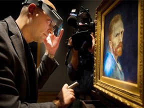 Allen Kosanovich, Associate Paintings Conservator  with the Wadsworth Atheneum Museum of Art examines a Vincent van Gogh self-portrait unveiled Tuesday at the Montreal Museum of Fine Arts in Montreal, on Tuesday, September 30, 2014.