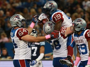 Alouettes' S.J. Green celebrates his touchdown against the Toronto Argonauts with teammates Luc Brodeur-Jourdain (#58) and Ryan Bomben (#64) during their game at Rogers Centre on October 18, 2014 in Toronto.