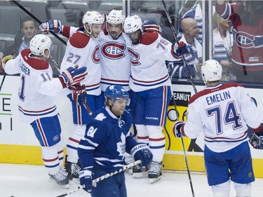 Montreal Canadiens, left to right, Brendan Gallagher, Alex Galchenyuk, Tomas Plekanec, P.K. Subban, and Alexei Emelin celebrate Plekanec's goal in front of Toronto Maple Leafs' Phil Kessel during second period NHL action in Toronto on Wednesday, October 8, 2014.