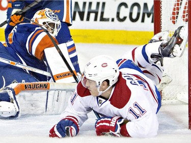 Montreal Canadiens' Brendan Gallagher crashes into Edmonton Oilers goalie Ben Scrivens during first-period action in Edmonton on Monday, Oct. 27, 2014.