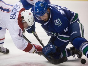 The Canadiens' Brendan Gallagher and the Canucks' Brad Richardson battle for the puck after a faceoff during game in Vancouver on Oct. 30, 2014.