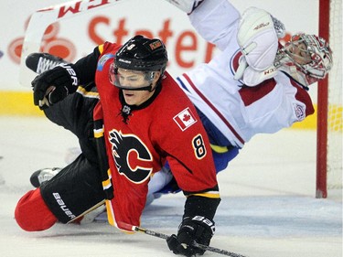 Joe Colborne of the Calgary Flames slams into Montreal Canadiens goalie Carey Price, earning a minor penalty, during the first period at the Saddledome in Calgary on Tuesday,  Oct. 28, 2014.
