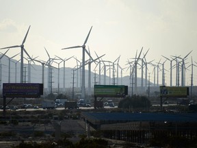 Giant wind turbines are powered by strong winds as traffic moves on Interstate 10 on March 27, 2013 in Palm Springs, California. According to reports, California  leads the nation in green technology and has the lowest greenhouse gas emissions per capita, even with a growing economy and population.