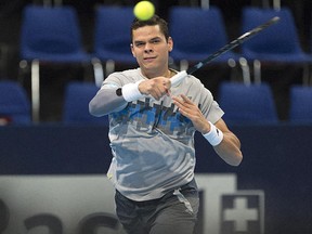 Canada's Milos Raonic returns a ball to Donald Young of the U.S. during their match at the Swiss Indoors tennis tournament in Basel, Switzerland on Oct. 23, 2014.