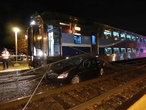 The car that was stuck between two barrier gates at the level crossing at Terrasse-Vaudreuil on Oct. 16, 2014, was dragged by an AMT train. The driver was able to escape the vehicle before it was struck by the train.