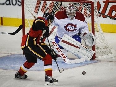 Johnny Gaudreau, bearing down on Carey Price in Calgary on Oct. 28, 2014, is the Flames' leading scorer.