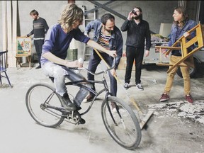 Jimmy Hunt, on the bike surrounded by bandmates,  has calmed since Chocolat went on hiatus in 2010. Emmanuel Ethier is drinking the beer.