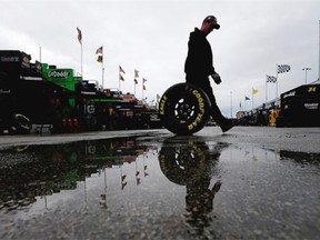 A crew member walks in the garage area prior to practice for the NASCAR Sprint Cup Series Hollywood Casino 400 at Kansas Speedway on Oct. 3, 2014 in Kansas City, Kansas.