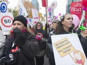 Daycare workers demonstrate in Montreal, Monday, October 20, 2014.