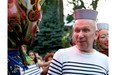 Designer Jean Paul Gaultier talks to Christelle Germelus after cutting the ribbon to mark the beginning of the Pinkarnaval parade on Ste-Catherine St. in Montreal on July 16, 2011.