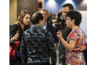 Lin Diran, the father of murder victim Lin Jun, chats with a lawyer prior to entering the Palais de Justice in Montreal, on Tuesday, Sept. 30, 2014 for day two of the Luka Magnotta trial.