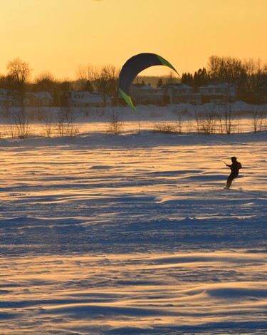 Even though the air was frosty and the wind brisk, a brave parasailer enjoys great winter fun.