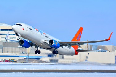 Cuba-bound Sunwing Boeing 737-800 lifts off from runway 24L, Pierre Elliot Trudeau Airport on a cold winter afternoon. Photo taken with a Nikon D7100 digital SLR camera using a Nikon 70-300mm lens.