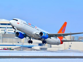 Cuba-bound Sunwing Boeing 737-800 lifts off from runway 24L, Pierre Elliot Trudeau Airport on a cold winter afternoon. Photo taken with a Nikon D7100 digital SLR camera using a Nikon 70-300mm lens.