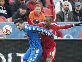 The Impact's Eric Miller, left, and Toronto FC's Jackson Goncalves battle for the ball during MLS action in Toronto on Oct. 18, 2014.