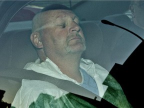 Shooting suspect Richard Henry Bain in the back of a police car as he arrives at the Montreal courthouse on Thursday, Sept. 6, 2012.