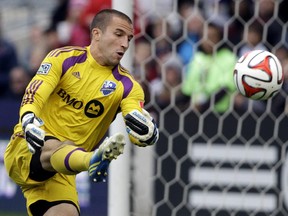 Impact goalkeeper Evan Bush blocks a shot by Chicago Fire forward Quincy Amarikwa during MLS game on Oct. 5, 2014, in Bridgeview, Ill.