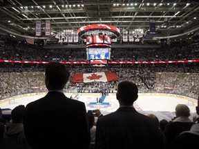 Fans stand for Canadian national anthem before the first game of the NHL season between the Maple Leafs and Canadiens in Toronto on Oct. 8, 2014.