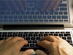 In this Feb. 27, 2013 photo illustration, hands type on a computer keyboard.