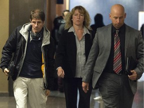 Witness Frank Rubert, left, from Berlin, Germany, leaves the courtroom with police investigators after testifying at the murder trial for Luka Rocco Magnotta Wednesday, Oct. 8, 2014 in Montreal.