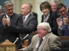 Quebec Health Minister Gaetan Barrette is applauded by his colleagues after he tabled legislation on health and social services Thursday, September 25, 2014 at the legislature in Quebec City.