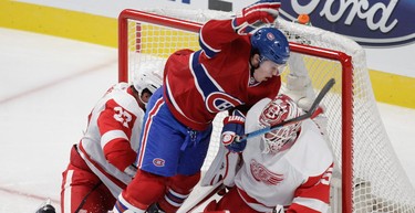 Brendan Gallagher of the Montreal Canadiens runs into goalie Jimmy Howard of the Detroit Red Wings. (John Kenney / MONTREAL GAZETTE)