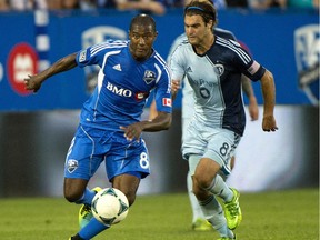 Tje Impact's Patrice Bernier breaks away from Sporting Kansas City's Graham Zusi during MLS action at Saputo Stadium on July 27, 2013.