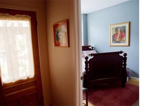 A guest room off the main entrance in Renee Lescop's condo Thursday, August 28, 2014 in Montreal. Her ground floor condo is one of a group of apartments built a century ago. A painting on the wall done  by Quebec artist  Jeanne Rhume in the late 1930's is of her mother Marguerite Lescop who is now 99-years-old.