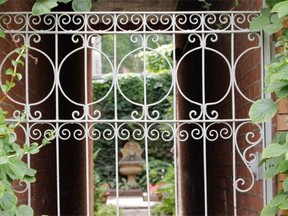 A view of a gate that opens to a passageway to a patio garden shared by Renee Lescop and her neighbours Thursday, August 28, 2014 in Montreal. Her ground floor condo is one of a group of apartments built a century ago.