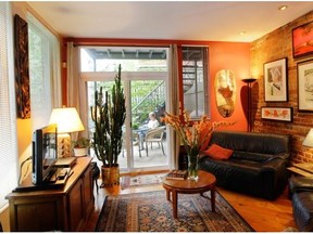 A view of the living room in Renee Lescop's condo Thursday, August 28, 2014 in Montreal which leads to her back patio. Her ground floor condo is one of a group of apartments built a century ago.