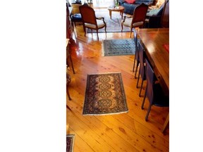 A view of the wood plank floors and carpets in the dining room in Renee Lescop's condo Thursday, August 28, 2014 in Montreal. Her ground floor condo is one of a group of apartments built a century ago.